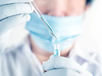 Close up a scientist working in laboratory to analyze blue extracted of DNA molecules in micro tube.